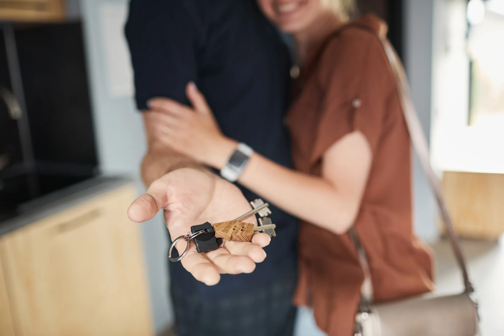 Hand holding keys to new home